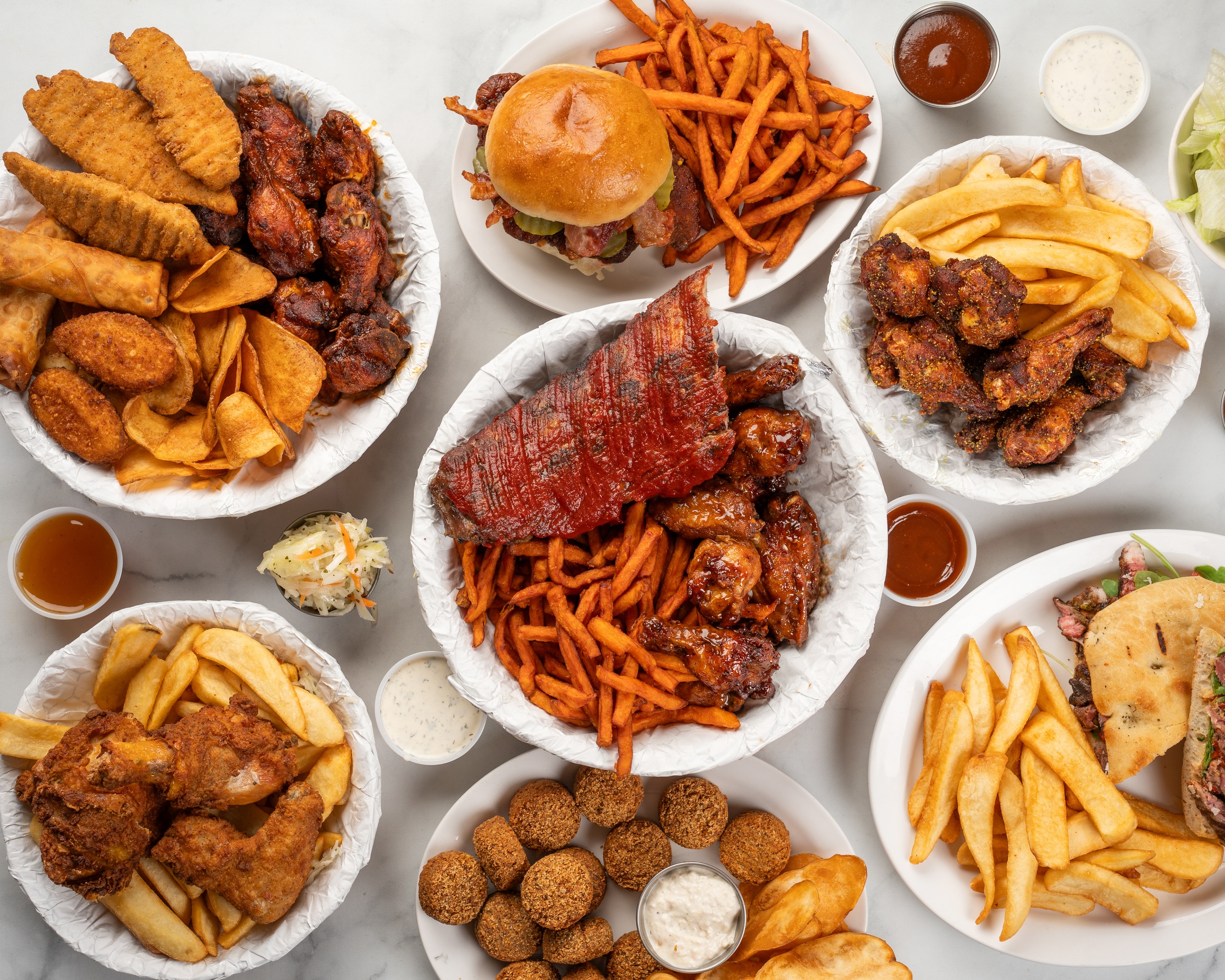 A spread of Bistro on Avenue wings, ribs, and sandwiches